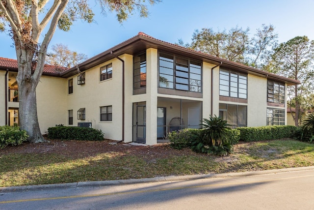 view of front of house with stucco siding and a tile roof