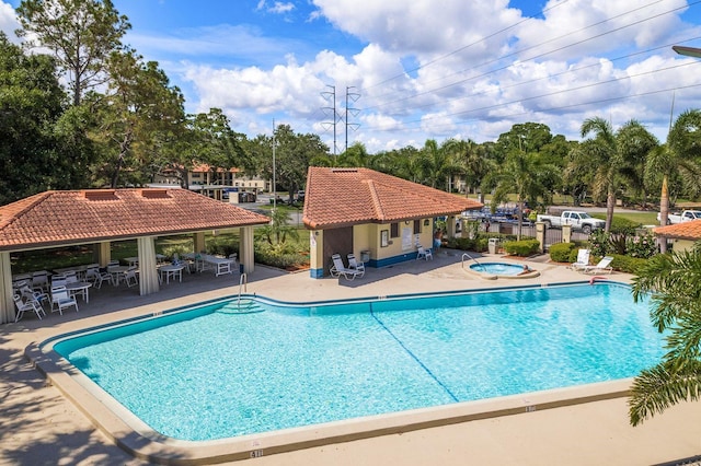 pool featuring a gazebo, a hot tub, and a patio