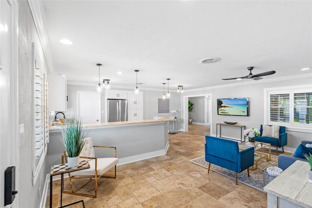 living area featuring visible vents, baseboards, ceiling fan, stone finish flooring, and crown molding