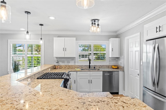 kitchen featuring tasteful backsplash, crown molding, light stone counters, stainless steel appliances, and a sink