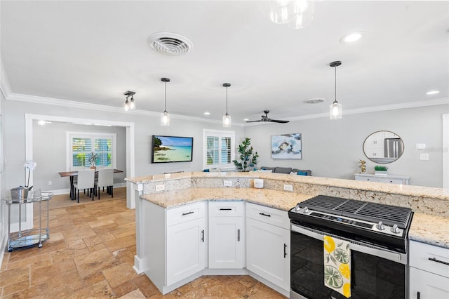 kitchen with gas range, stone tile flooring, visible vents, and ornamental molding