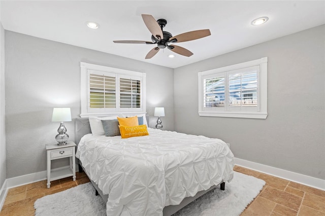 bedroom featuring stone finish floor, recessed lighting, baseboards, and ceiling fan