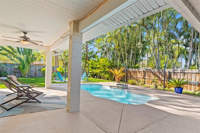 view of pool featuring a yard, a fenced backyard, ceiling fan, and a patio