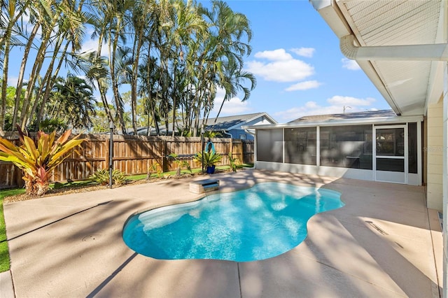 view of pool with a patio area, a fenced in pool, a fenced backyard, and a sunroom