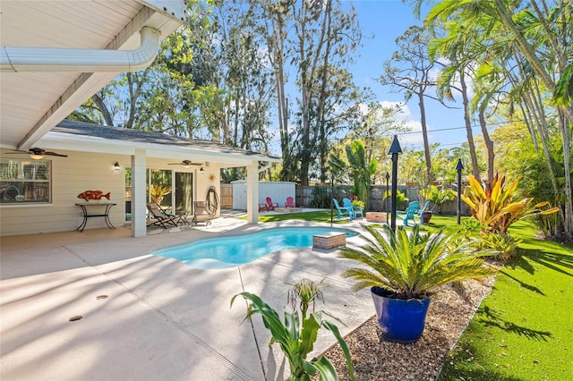 view of pool with a patio area, a fenced backyard, a fenced in pool, and ceiling fan