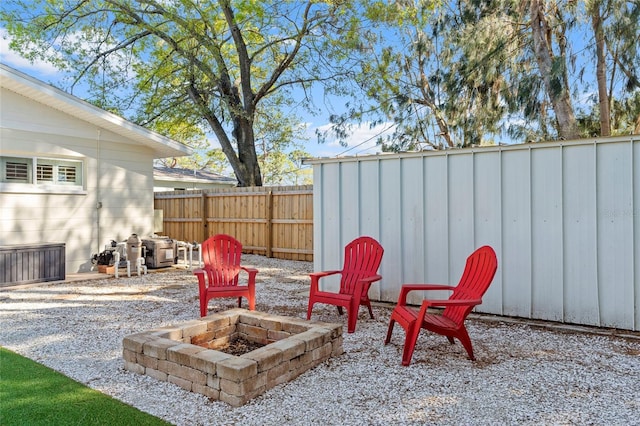 view of patio / terrace with a fire pit and a fenced backyard