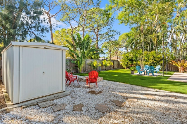 view of yard with a fenced backyard, a storage shed, an outdoor structure, and a patio area