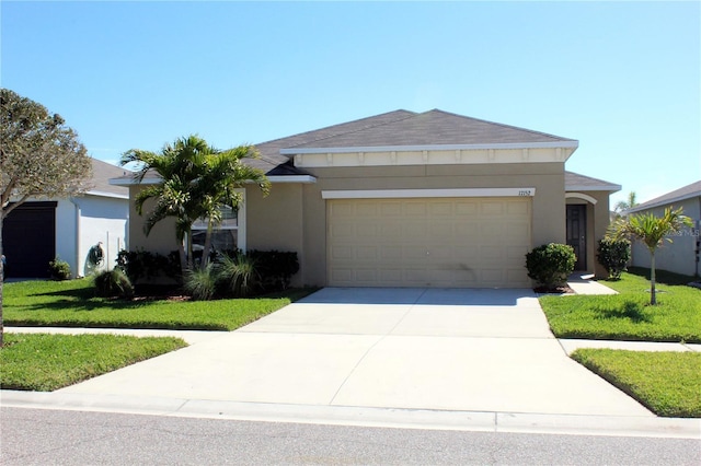 ranch-style house with a garage, driveway, a front lawn, and stucco siding