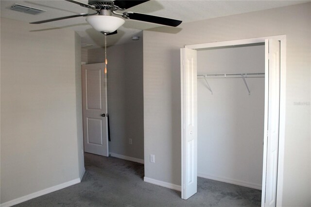 unfurnished bedroom with a ceiling fan, visible vents, baseboards, a closet, and carpet