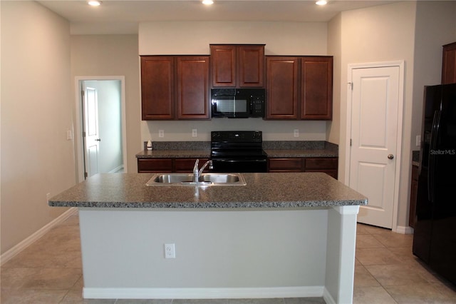 kitchen featuring light tile patterned floors, a kitchen island with sink, recessed lighting, a sink, and black appliances