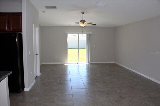 spare room with ceiling fan, light tile patterned floors, visible vents, and baseboards