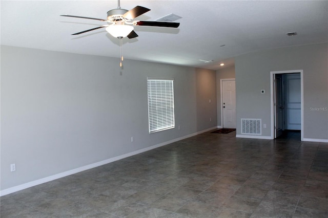 spare room featuring ceiling fan, visible vents, and baseboards