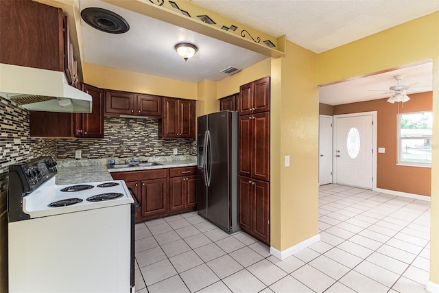 kitchen featuring a sink, range with electric cooktop, stainless steel fridge, and decorative backsplash