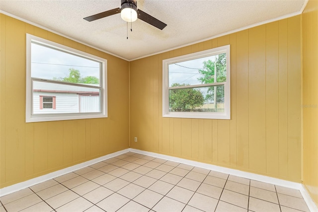 unfurnished room featuring a textured ceiling, a ceiling fan, and baseboards