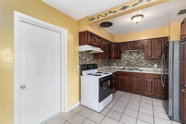 kitchen featuring range with electric stovetop, light countertops, visible vents, freestanding refrigerator, and under cabinet range hood