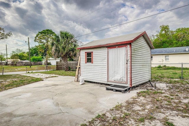 view of outdoor structure with a fenced backyard and an outdoor structure