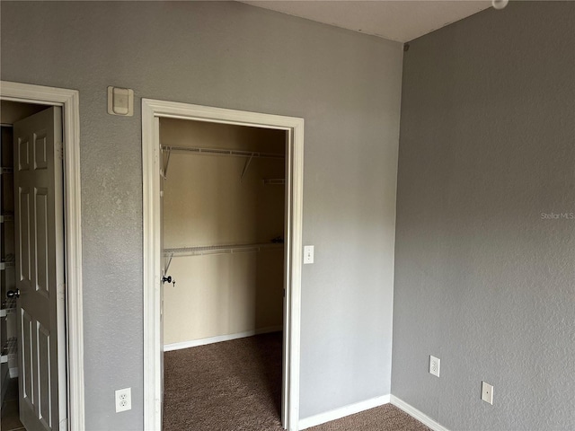 unfurnished bedroom with carpet, baseboards, and a closet