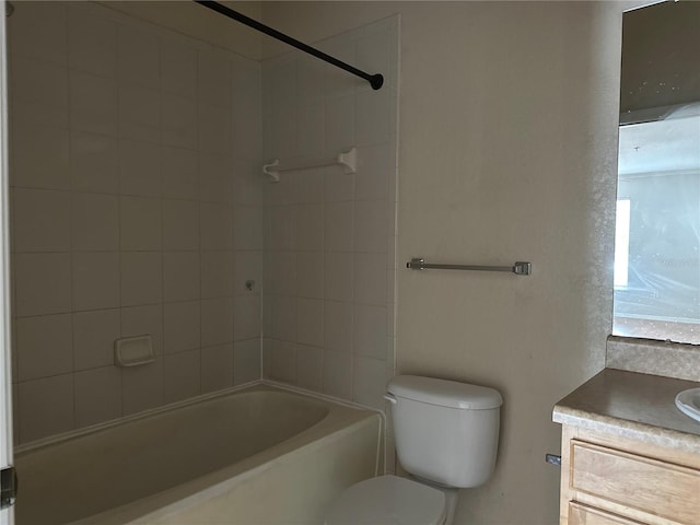 full bathroom featuring washtub / shower combination, vanity, and toilet