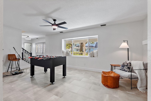 9067 Cypress Trl, Seminole, FL 33777 - rec room featuring ceiling fan, baseboards, and a textured ceiling