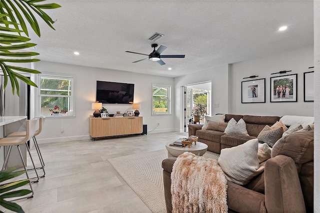 9067 Cypress Trl, Seminole, FL 33777 - living room featuring ceiling fan, recessed lighting, baseboards, and a textured ceiling