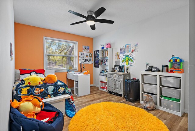 9067 Cypress Trl, Seminole, FL 33777 - bedroom with light wood-style flooring, baseboards, and ceiling fan