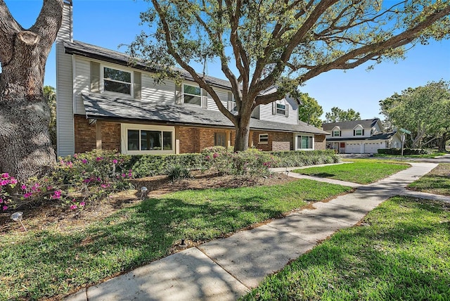 9067 Cypress Trl, Seminole, FL 33777 - traditional home featuring brick siding, a front lawn, and a chimney
