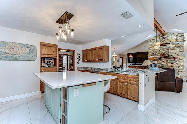 kitchen with visible vents, a peninsula, marble finish floor, and open floor plan