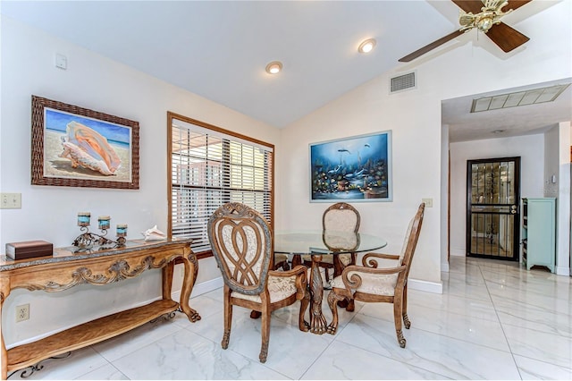 dining room with visible vents, baseboards, marble finish floor, and vaulted ceiling