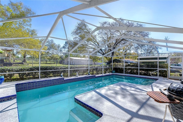 view of swimming pool with a fenced in pool, a patio area, a lanai, and fence