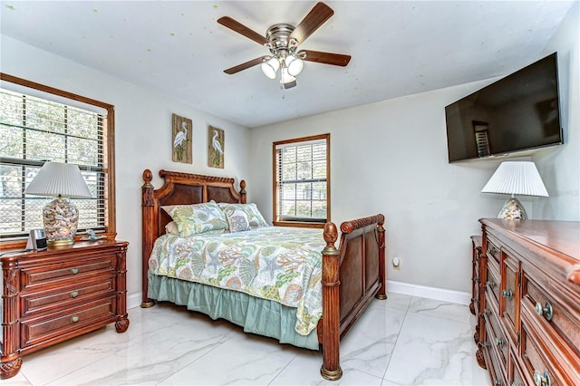 bedroom featuring a ceiling fan, baseboards, and marble finish floor