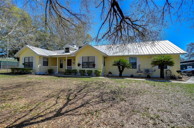 view of front of home with metal roof, covered porch, and a standing seam roof