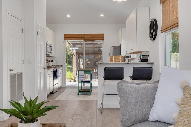 kitchen featuring visible vents, light wood-style flooring, appliances with stainless steel finishes, and a healthy amount of sunlight