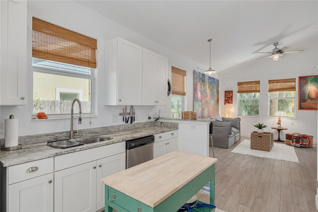 kitchen featuring light wood-style flooring, a sink, open floor plan, white cabinetry, and dishwasher