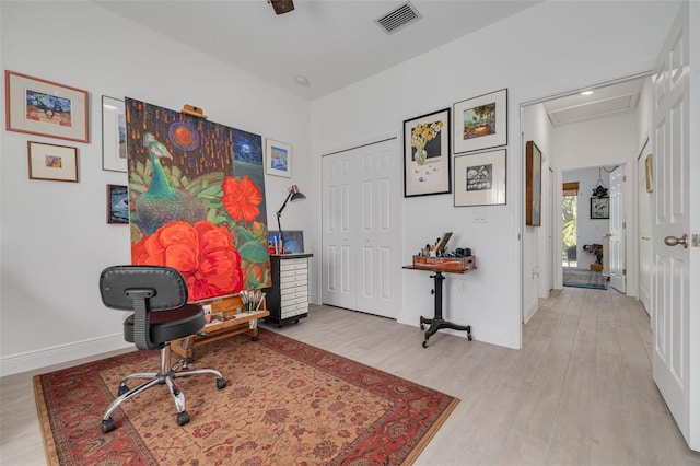 office area with attic access, wood finished floors, visible vents, and baseboards