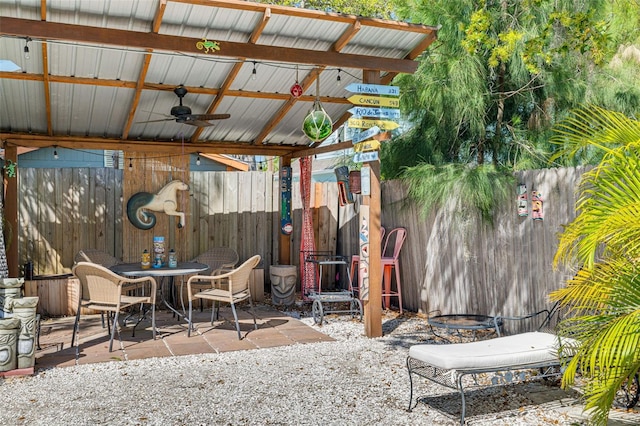 view of patio with outdoor dining area, a fenced backyard, and ceiling fan