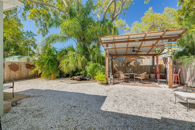 view of yard featuring a patio area, a fenced backyard, and ceiling fan