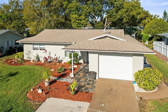 ranch-style house with fence, a front yard, roof with shingles, a garage, and driveway