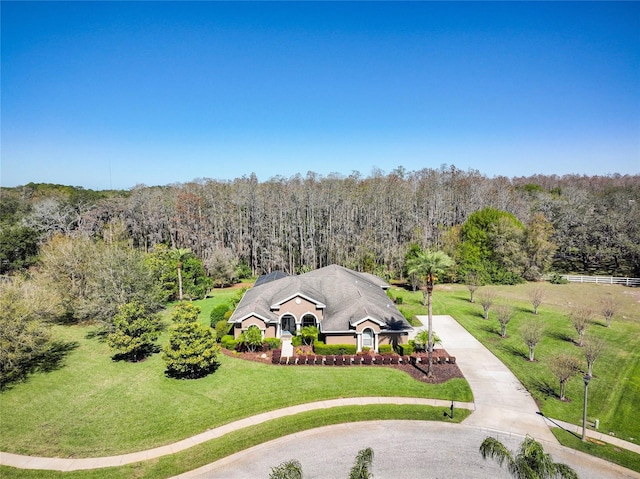 birds eye view of property with a forest view