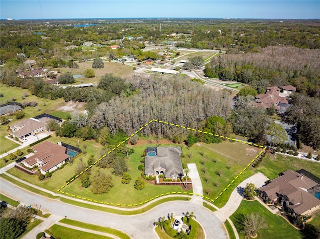 drone / aerial view featuring a wooded view