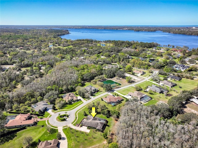 bird's eye view featuring a wooded view and a water view