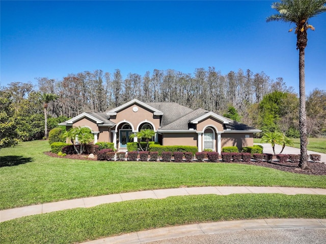 view of front of home featuring a front lawn and stucco siding