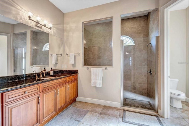 full bathroom featuring baseboards, toilet, tiled shower, tile patterned floors, and vanity