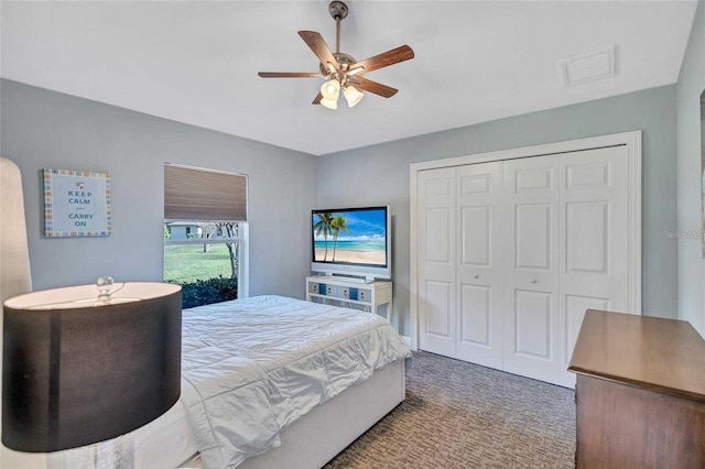 bedroom featuring visible vents, carpet floors, a closet, and ceiling fan