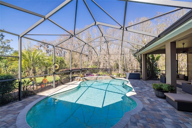 pool featuring glass enclosure and a patio