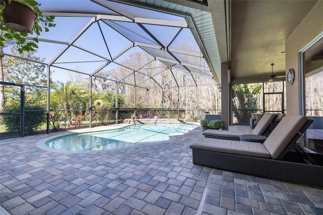 outdoor pool featuring a ceiling fan, a lanai, and a patio area