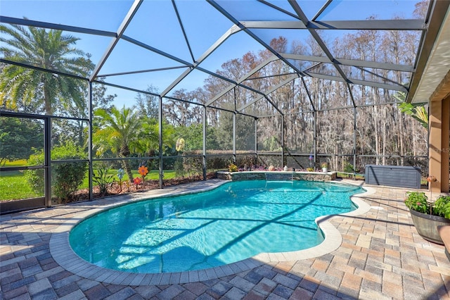 outdoor pool with glass enclosure and a patio