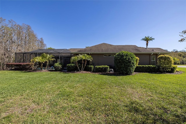 view of home's exterior featuring a lanai, a lawn, and stucco siding