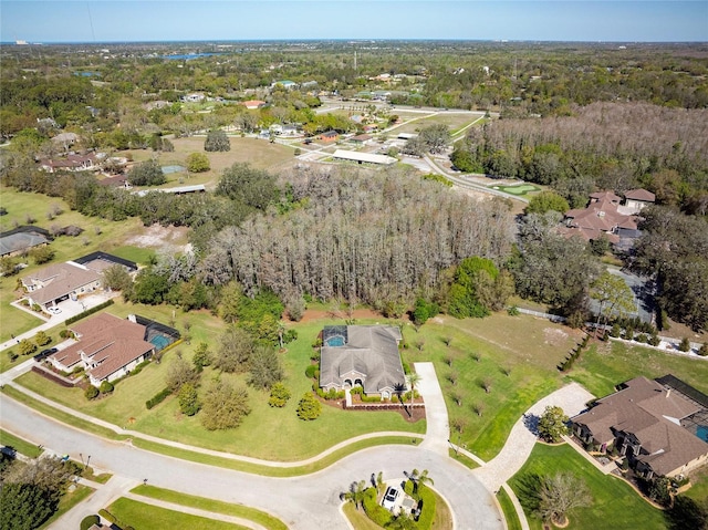 bird's eye view with a wooded view