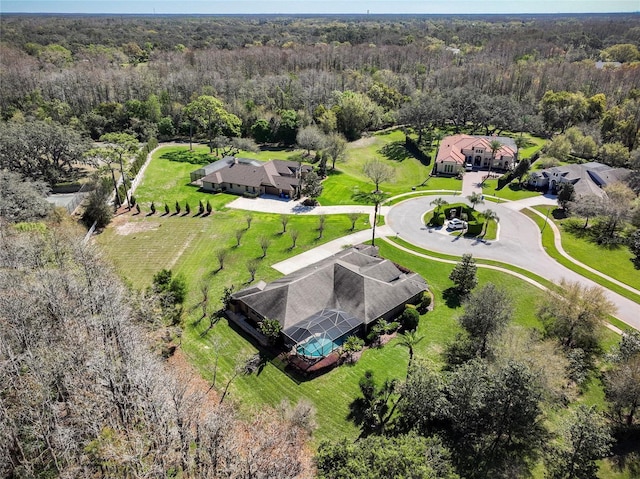 birds eye view of property with a forest view