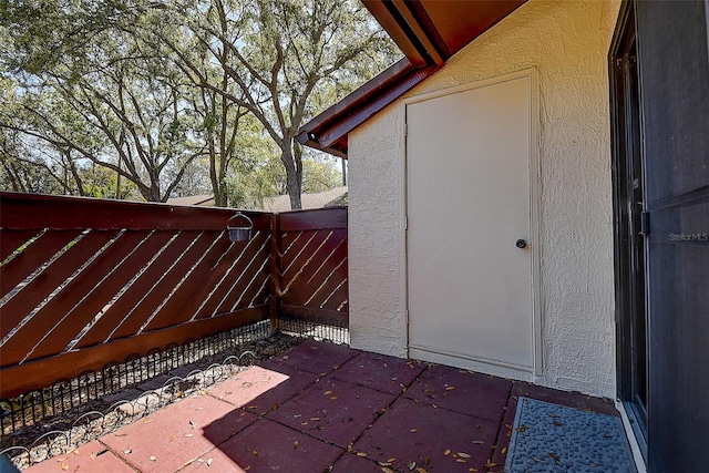 exterior space featuring a patio area, stucco siding, and fence